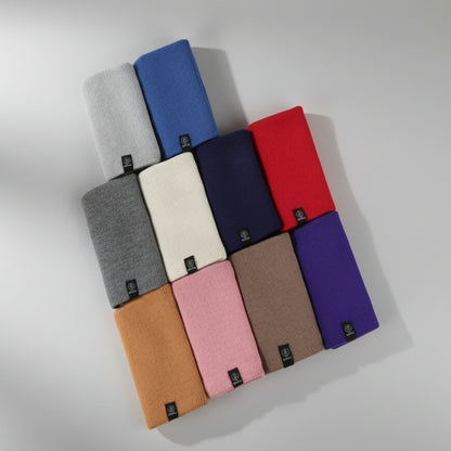 Collection of folded fabrics in various colors on a white background